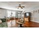 Cozy living area showcasing hardwood floors, neutral tones, and a ceiling fan at 7 Pondview Ct, Brownsburg, IN 46112