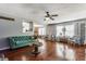 Spacious living room with hardwood floors, gray walls, and a green couch at 7 Pondview Ct, Brownsburg, IN 46112