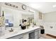 Bathroom featuring double sinks with gray cabinets, a large mirror, and a tub at 7252 Lockford N, Avon, IN 46123
