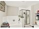 Bathroom features soaking tub and frameless shower next to double sinks and storage at 7252 Lockford N, Avon, IN 46123