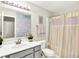 Bathroom features a stylish vanity with gray cabinets and a shower with a striped curtain at 7252 Lockford N, Avon, IN 46123