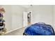 Neutral bedroom with blue bedding and a door leading into the kitchen at 7252 Lockford N, Avon, IN 46123