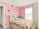 Whimsical bedroom with a pink polka dot wall and floral bedding at 7252 Lockford N, Avon, IN 46123