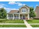 Charming two-story home features a welcoming front porch, green lawn, and beautiful landscaping at 7252 Lockford N, Avon, IN 46123