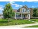 Lovely two-story home with a covered porch, complemented by lush green lawn and mature trees at 7252 Lockford N, Avon, IN 46123