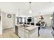 Open concept kitchen featuring an island with marble countertops that overlooks a dining and living room at 7252 Lockford N, Avon, IN 46123