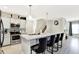 Modern kitchen featuring a marble counter island with dark leather high chairs and stainless steel appliances at 7252 Lockford N, Avon, IN 46123