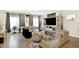 Open-concept living room with modern decor, including a large entertainment center and stylish sofas at 7252 Lockford N, Avon, IN 46123