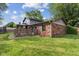 Lawn featuring a brick house with a wooden deck topped with a gazebo and privacy screens at 750 Hillcrest Dr, Greenwood, IN 46142