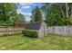 Fenced-in backyard showcasing a storage shed and trimmed hedges in a well-maintained lawn at 750 Hillcrest Dr, Greenwood, IN 46142