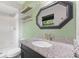This bathroom includes a black vanity with granite countertop, a shower and hexagon mirror at 750 Hillcrest Dr, Greenwood, IN 46142