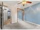 Bedroom features carpet floors, a closet, a ceiling fan, and blue accent wall at 750 Hillcrest Dr, Greenwood, IN 46142