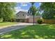 View of exterior with a basketball court, two story construction and a garage at 750 Hillcrest Dr, Greenwood, IN 46142