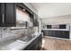 Bright kitchen features a stainless steel sink, granite countertops, and view into the connected living space at 750 Hillcrest Dr, Greenwood, IN 46142