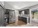 Modern kitchen with stainless steel appliances, dark cabinets, and ample counter space at 750 Hillcrest Dr, Greenwood, IN 46142