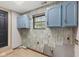 Functional laundry room features overhead cabinets and ample space for appliances at 750 Hillcrest Dr, Greenwood, IN 46142