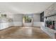 Bright living room with brick fireplace and large window, offering ample natural light at 750 Hillcrest Dr, Greenwood, IN 46142