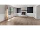 Spacious living room featuring a decorative brick fireplace, large window, and modern flooring at 750 Hillcrest Dr, Greenwood, IN 46142