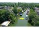 Aerial view of the property with lake access and private boat docks surrounded by lush greenery at 8069 Middle Bay Ln, Indianapolis, IN 46236