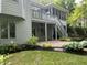 Backyard featuring multi-level deck, stone patio, and lush landscaping at 8069 Middle Bay Ln, Indianapolis, IN 46236