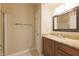 Neutral bathroom with a single sink vanity, large mirror, and a separate toilet room at 8069 Middle Bay Ln, Indianapolis, IN 46236