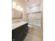 Updated bathroom featuring a sleek vanity, marble countertop, and sliding glass shower doors at 8069 Middle Bay Ln, Indianapolis, IN 46236