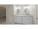 Bright bathroom with double sinks, white cabinets, marble countertops, and a glass shower at 8069 Middle Bay Ln, Indianapolis, IN 46236