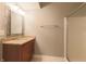This bathroom features a single sink vanity, a large mirror, and a shower with sliding glass doors at 8069 Middle Bay Ln, Indianapolis, IN 46236
