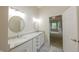 This elegant bathroom features double sinks, marble countertops, and a view into the bedroom at 8069 Middle Bay Ln, Indianapolis, IN 46236