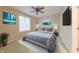 Calm bedroom with a ceiling fan, large window, neutral walls, and a serene art piece at 8069 Middle Bay Ln, Indianapolis, IN 46236