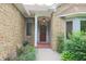 Close-up of a home's stone exterior and front entryway with a wooden door at 8069 Middle Bay Ln, Indianapolis, IN 46236
