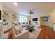 Well-lit living room with hardwood floors, a ceiling fan, and a comfortable seating area at 8069 Middle Bay Ln, Indianapolis, IN 46236