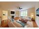 Bright living room with hardwood floors, fireplace, built-in shelves, and neutral furniture at 8069 Middle Bay Ln, Indianapolis, IN 46236
