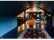Unique attic space with dark wood floors, red rug, movie light, and open floor plan at 825 E Washington St, Muncie, IN 47305