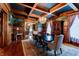 Beautiful dining room with hardwood floors, mural, decorative rug, and view to the living room at 825 E Washington St, Muncie, IN 47305