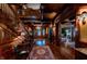 Spacious foyer with hardwood floors, elegant staircase, and a view into the living room at 825 E Washington St, Muncie, IN 47305