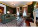 Comfortable sitting area with decorative fireplace, hardwood floors, and designer furniture at 825 E Washington St, Muncie, IN 47305