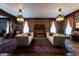 Stylishly furnished living room with two sofas, an ornate fireplace, and detailed wallpaper at 825 E Washington St, Muncie, IN 47305