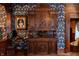 Close up of antique cabinet and patterned wallpaper with period portraits and phonograph at 825 E Washington St, Muncie, IN 47305