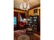 Cozy living room with a chandelier, large bookcase, and comfortable seating at 825 E Washington St, Muncie, IN 47305