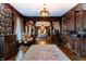 A stylish living room with detailed wood trim, patterned wallpaper, and vintage furnishings at 825 E Washington St, Muncie, IN 47305