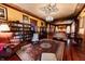 Spacious living room with hardwood floors, a chandelier, and decorative ceilings at 825 E Washington St, Muncie, IN 47305