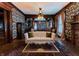 Elegantly decorated living room with a tufted sofa, beautiful wallpaper, and period lighting at 825 E Washington St, Muncie, IN 47305
