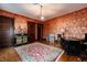 Living room featuring hardwood floors, vintage wallpaper, vintage furniture, and natural light at 825 E Washington St, Muncie, IN 47305