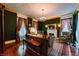 Cozy living room with decorative fireplace, chandelier, hardwood floors, and comfortable seating arrangement at 825 E Washington St, Muncie, IN 47305