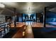 Lounge area with hardwood floors, vintage furniture, natural light, and a jukebox at 825 E Washington St, Muncie, IN 47305