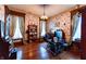 Home office space with hardwood floors, vintage wallpaper, natural light, and built-in shelving at 825 E Washington St, Muncie, IN 47305