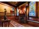 Charming sitting area with stained glass windows and detailed wood fireplace at 825 E Washington St, Muncie, IN 47305