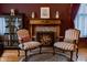 Elegant sitting room featuring a decorative fireplace and traditional furnishings at 825 E Washington St, Muncie, IN 47305
