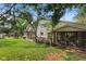 Backyard view showing the screened porch and the deck area surrounded by mature trees at 8435 Hilltop Ln, Martinsville, IN 46151